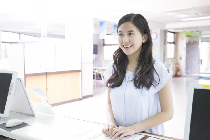 自動車学校で受付をする女子大生